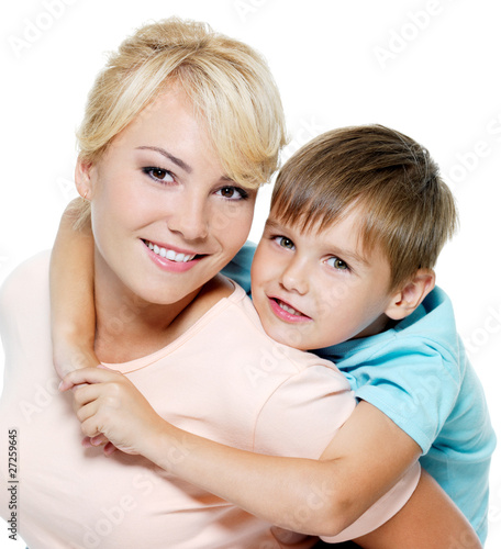 Happy mother and son posing on the white background