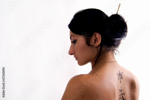 Portrait of the young girl standing back to the camera