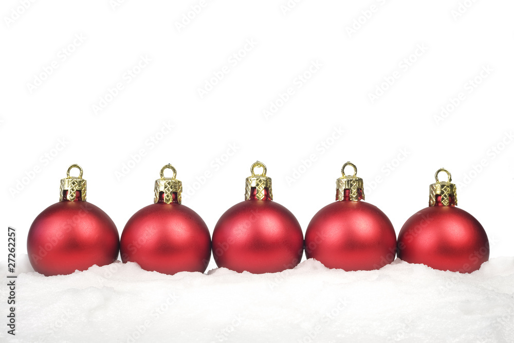 Row of red Christmas Balls in the snow,isolated on white backgro Row of red Christmas Balls in the snow,isolated on white backgro