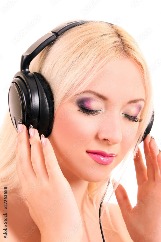 Beautiful young blonde woman with bright make-up listening music Beautiful young blonde woman with bright make-up listening music