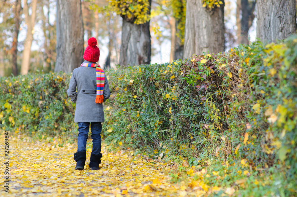 Little Miss. Pretty cute girl walks in autumn park Little Miss. Pretty cute girl walks in autumn park