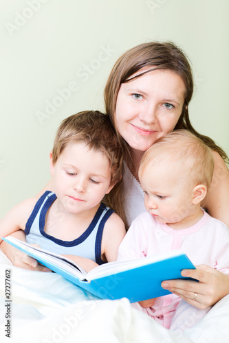 Family reading in bed