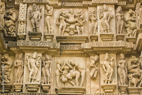 Erotic sculptures on ancient Hindu Temple at Khajuraho, India photo