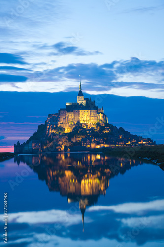 Mont Saint Michel abbaye reflected in the bay at sunset, France