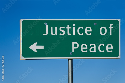 Justice of Peace sign with blue sky background © Natalia Bratslavsky