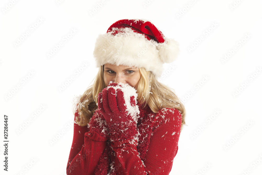 Young woman with Santa hat holding snow Young woman with Santa hat holding snow