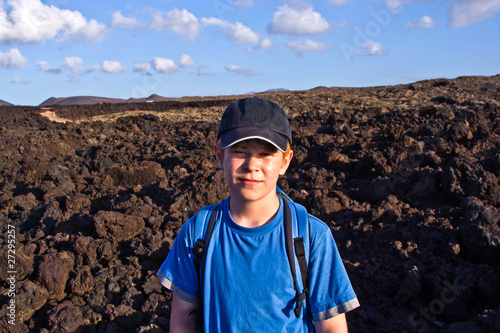 young boy walking through volcanic area in Lanzarote photo