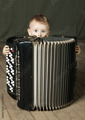 The boy is going to play an accordion