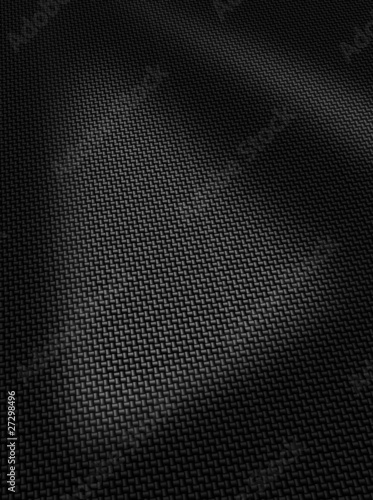 Woven black carbon fibre surface texture vertical