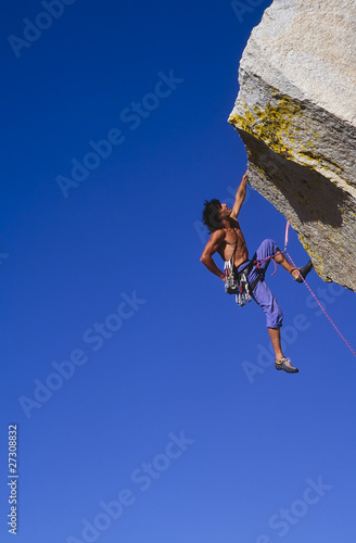 Climber clinging to a cliff.