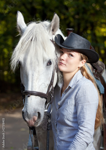 Young Lady hugging her horse © Sergey Lavrentev