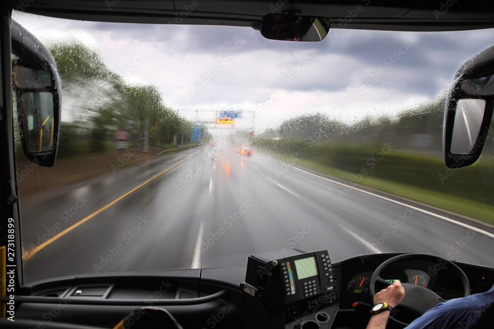 front window of bus and rainy road front window of bus and rainy road