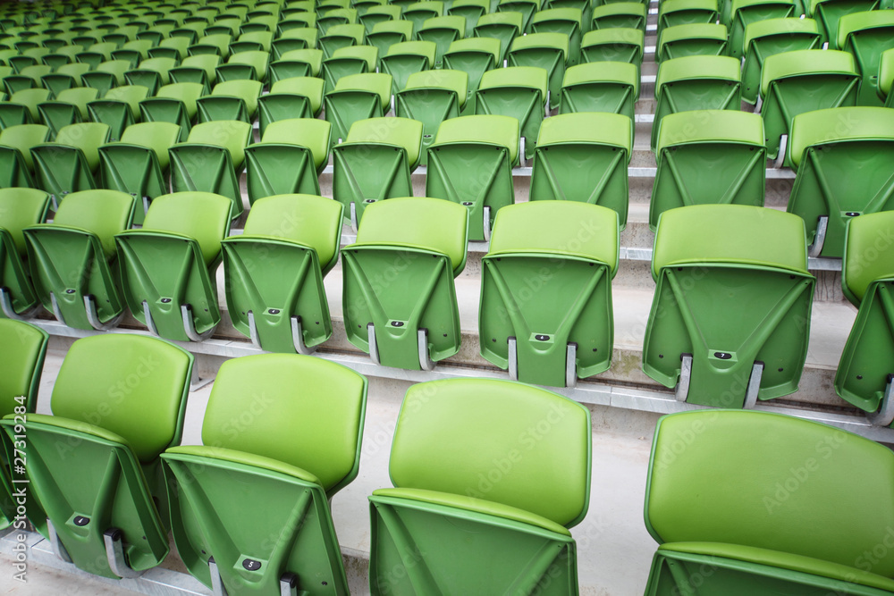 Obraz premium Rows of folded seats in empty stadium. Focus on front seats