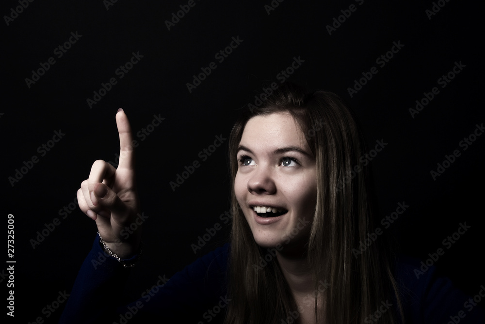 Portrait of a young girl pointing at something Portrait of a young girl pointing at something