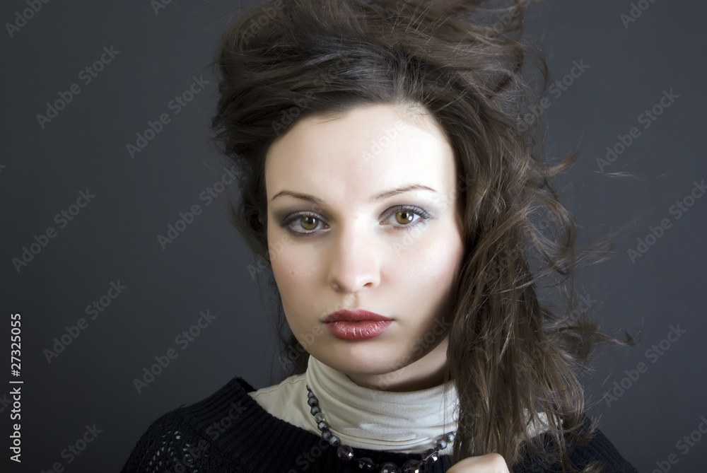 Fototapeta premium Portrait of a young beautiful brunette close-up