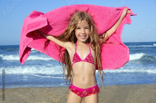 Photo Beach little girl playing pink towel and wind