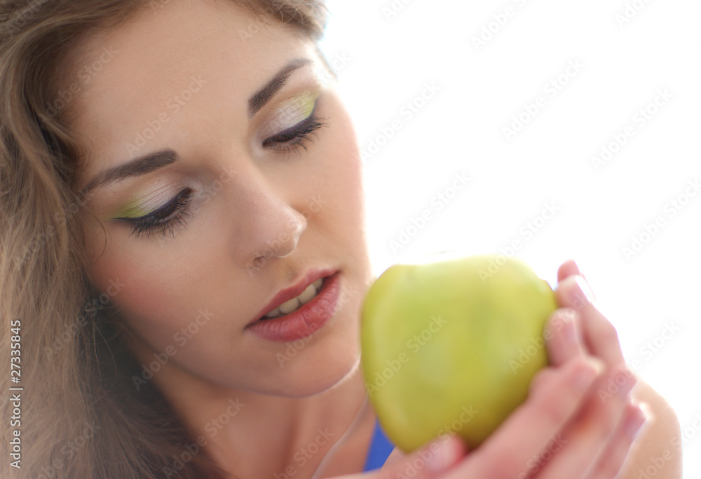 Portrait of a young brunette holding a green apple Portrait of a young brunette holding a green apple