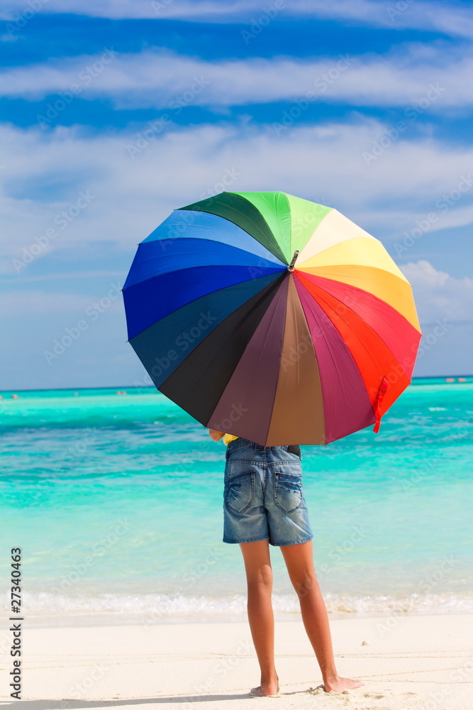 Child with parasol on beach