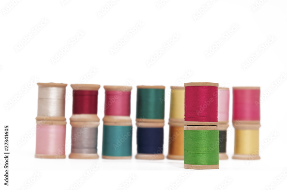 Stacked Spools of Colorful Thread on a White Background Stacked Spools of Colorful Thread on a White Background