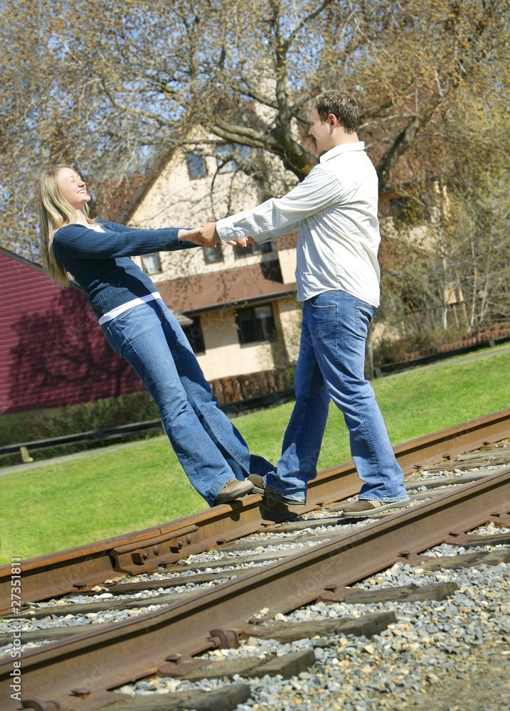 Couple Holding Hands On Railroad Track Couple Holding Hands On Railroad Track