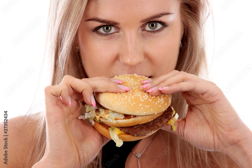 Young Woman Eating Hamburger. Model Released