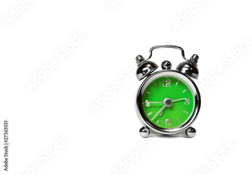 green alarm clock over white