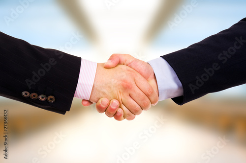 Closeup of business people shaking hands at the office