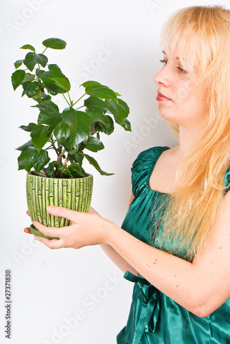 Young girl with the small plant
