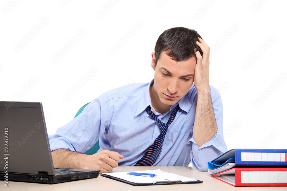 Desperate businessman in the office looking down