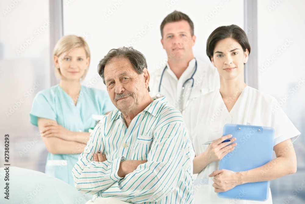 Old patient with doctors and nurse Old patient with doctors and nurse