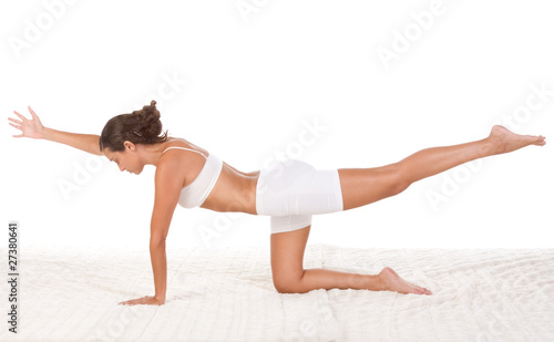 yoga pose - female in sport clothes performing exercise