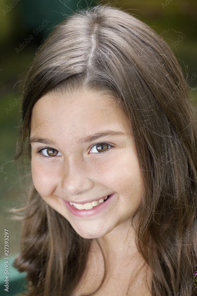 Beautiful little brown eyed eight year old girl outdoors Beautiful little brown eyed eight year old girl outdoors