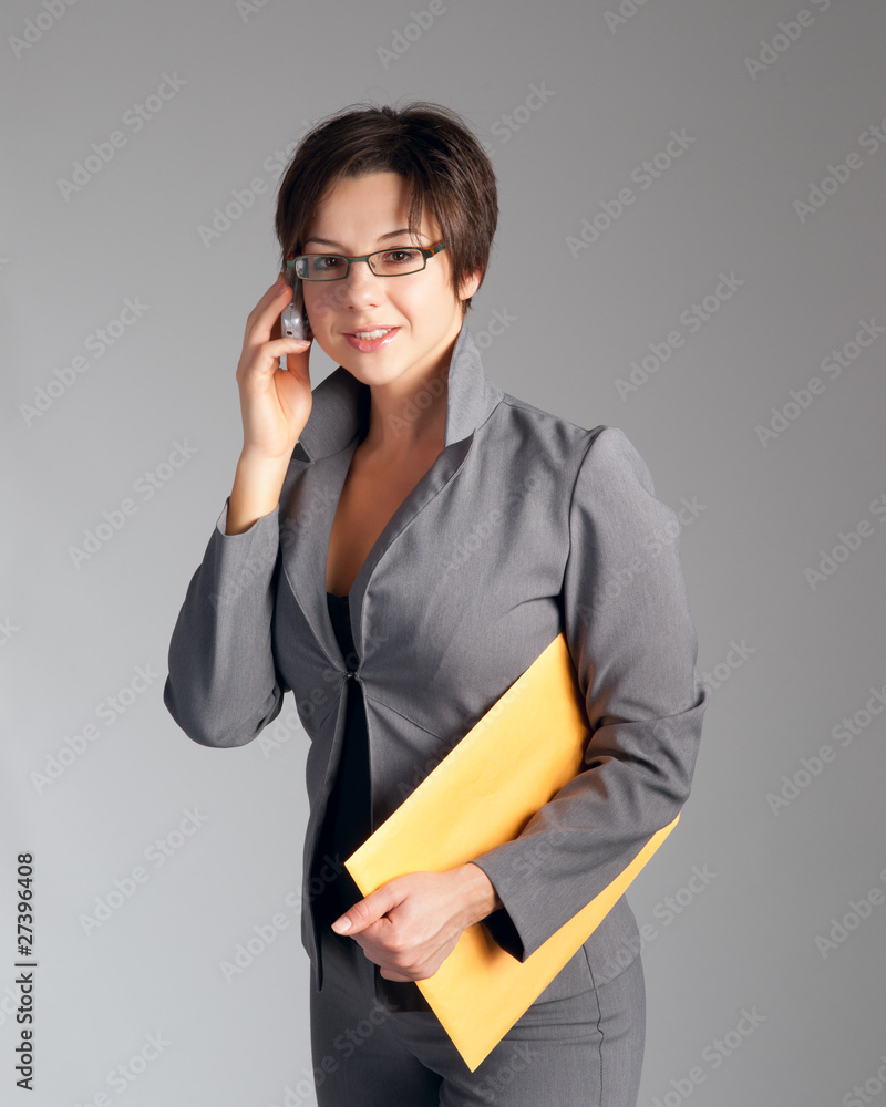 Beautiful young business woman talking on cellphone Beautiful young business woman talking on cellphone
