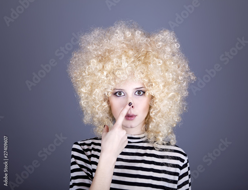 Portrait of funny girl in blonde wig.