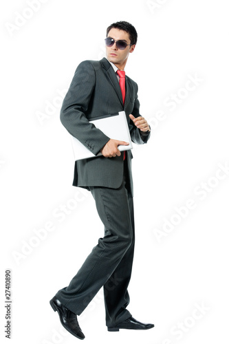 Businessman or hacker in sun glasses with laptop running
