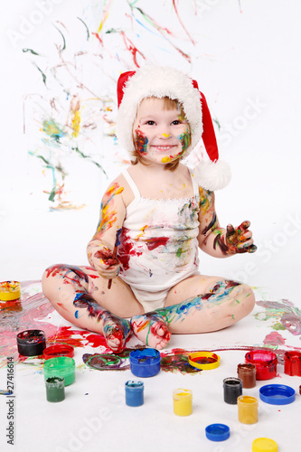 little girl bedaubed with bright colors