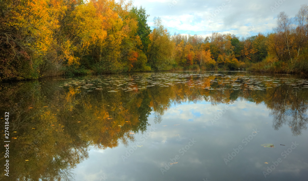 Beautiful Autumn Fall scene reflected in smooth lake
