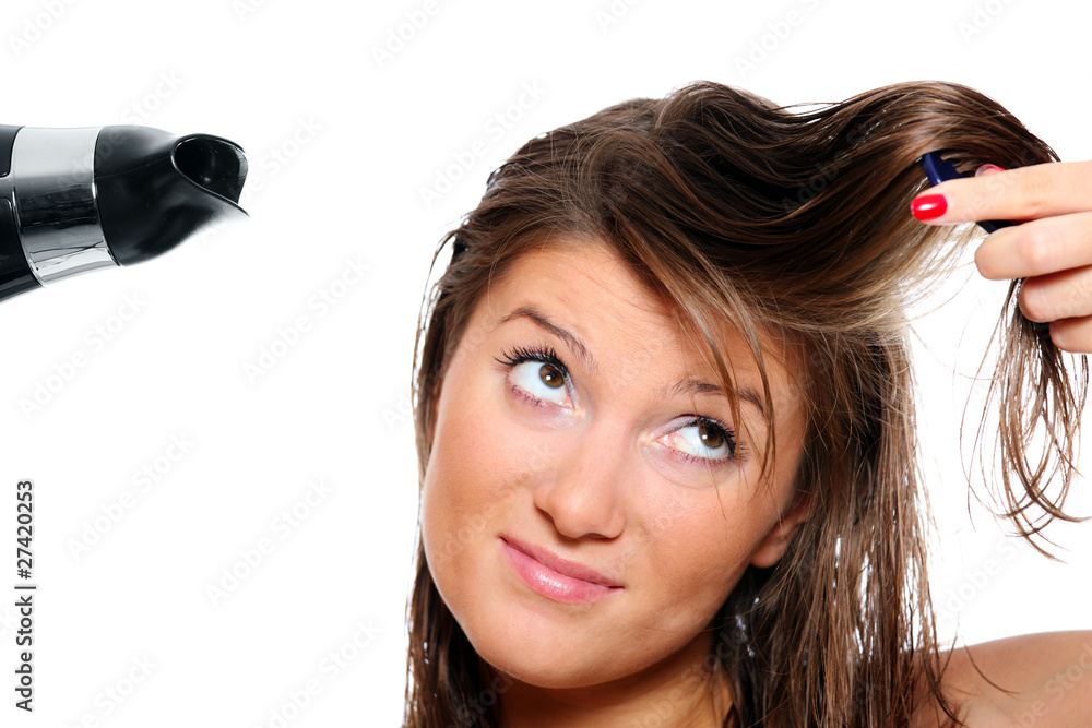 Young woman trying to brush her hair Young woman trying to brush her hair