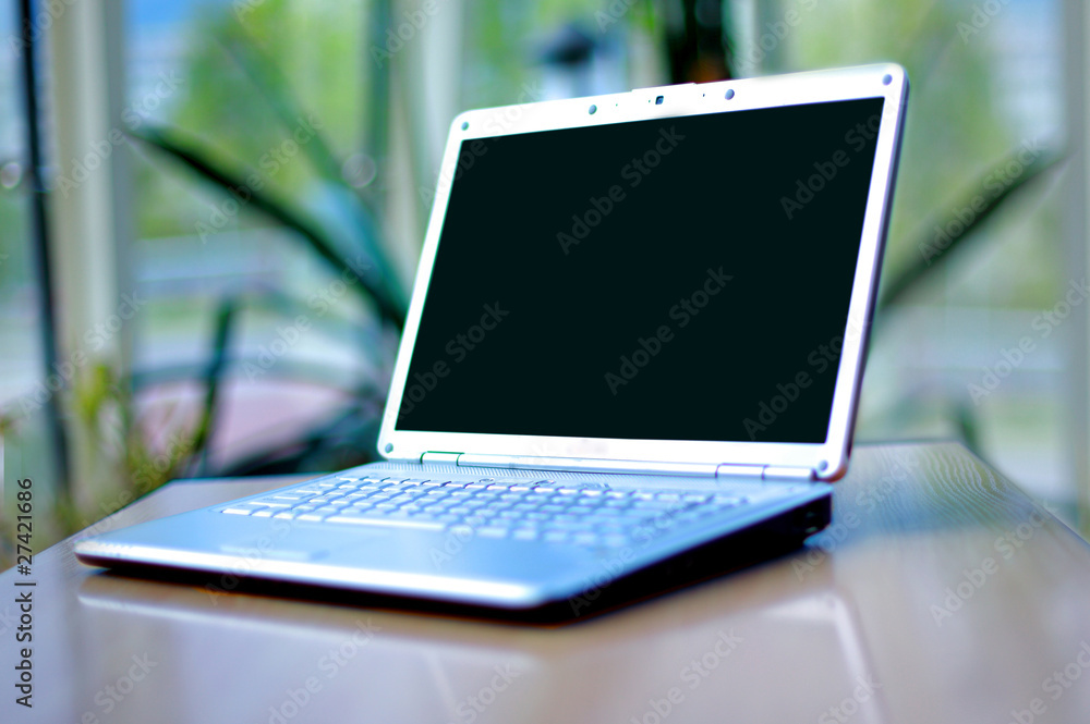thin laptop on office desk thin laptop on office desk