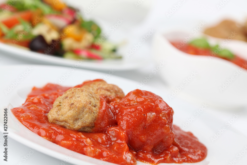 Roast meatballs with tomato sauce. Shallow DOF