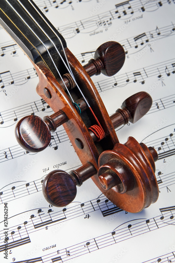 Naklejka premium Violin Scroll on Sheet Music