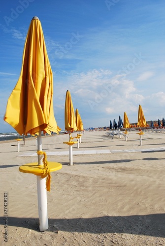 Yellow umbrellas on the beach, Rimini, Italy © Crisferra