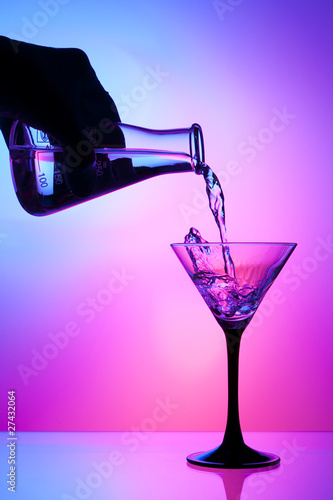 Pouring liquid from a flask into a cocktail