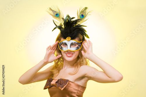 Portrait of a young woman wearing a carnival mask