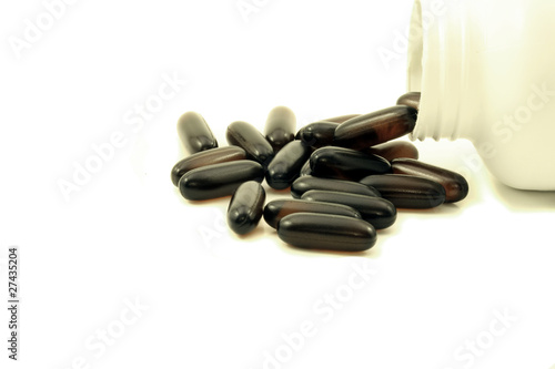 Vitamin Gel Capsules Spilling Out Of Bottle