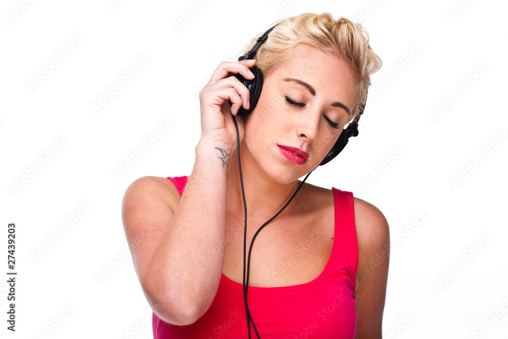 Naklejka premium Young woman listening to music with headphones with eyes closed