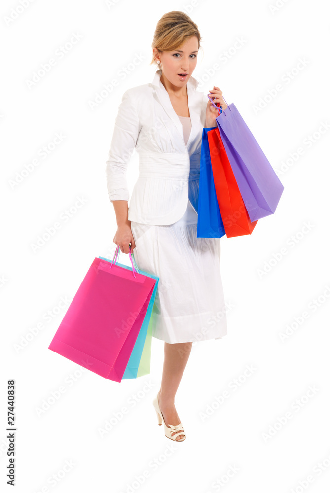Young woman with shopping bags standing isolated on white Young woman with shopping bags standing isolated on white