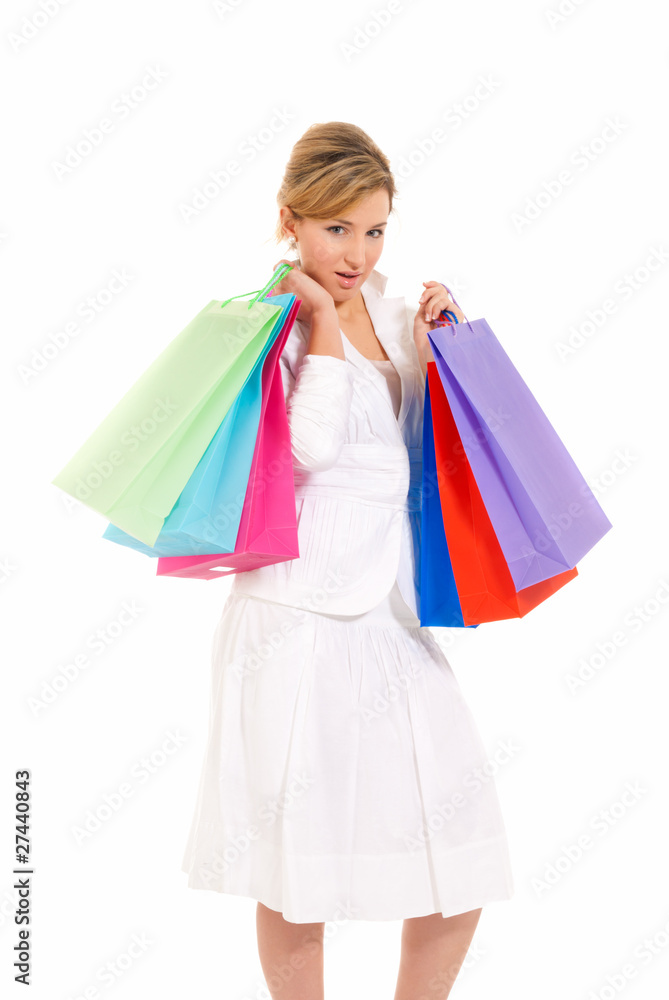 Young woman with shopping bags standing isolated on white