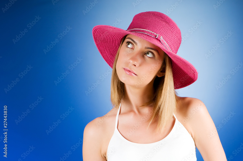 Young girl with beach hat against gradient background Young girl with beach hat against gradient background