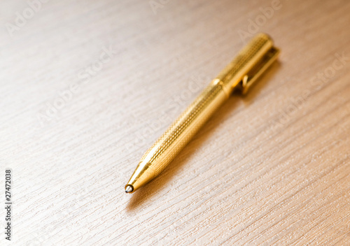 Writing silver pen on the wooden background